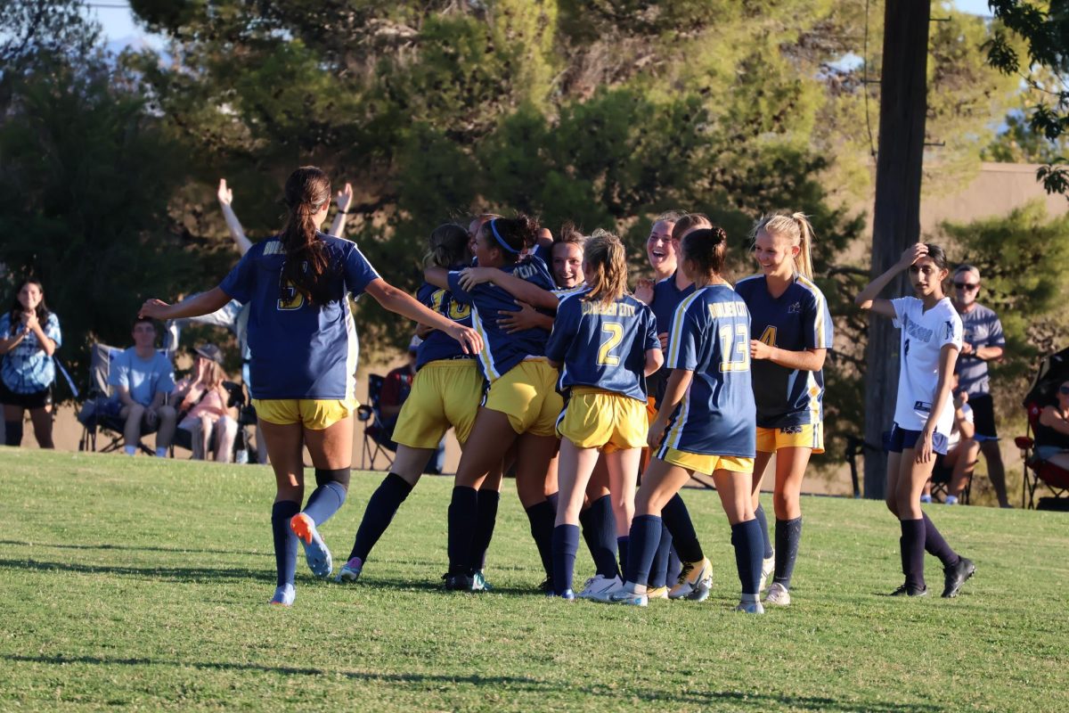 The Varsity team rushing to celebrate the game winning goal. 