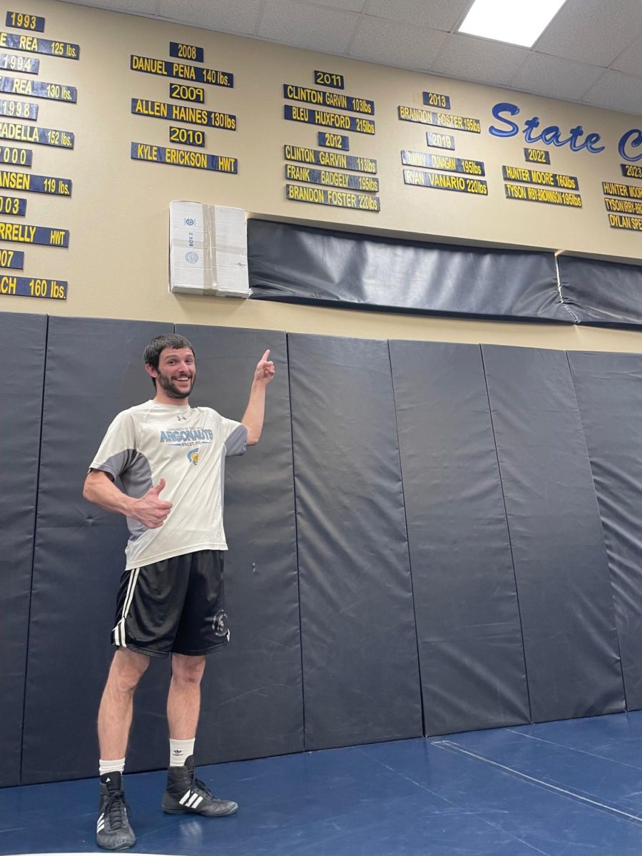 Coach Clinton Garvin showing off his state championships when he wrestled at BCHS.