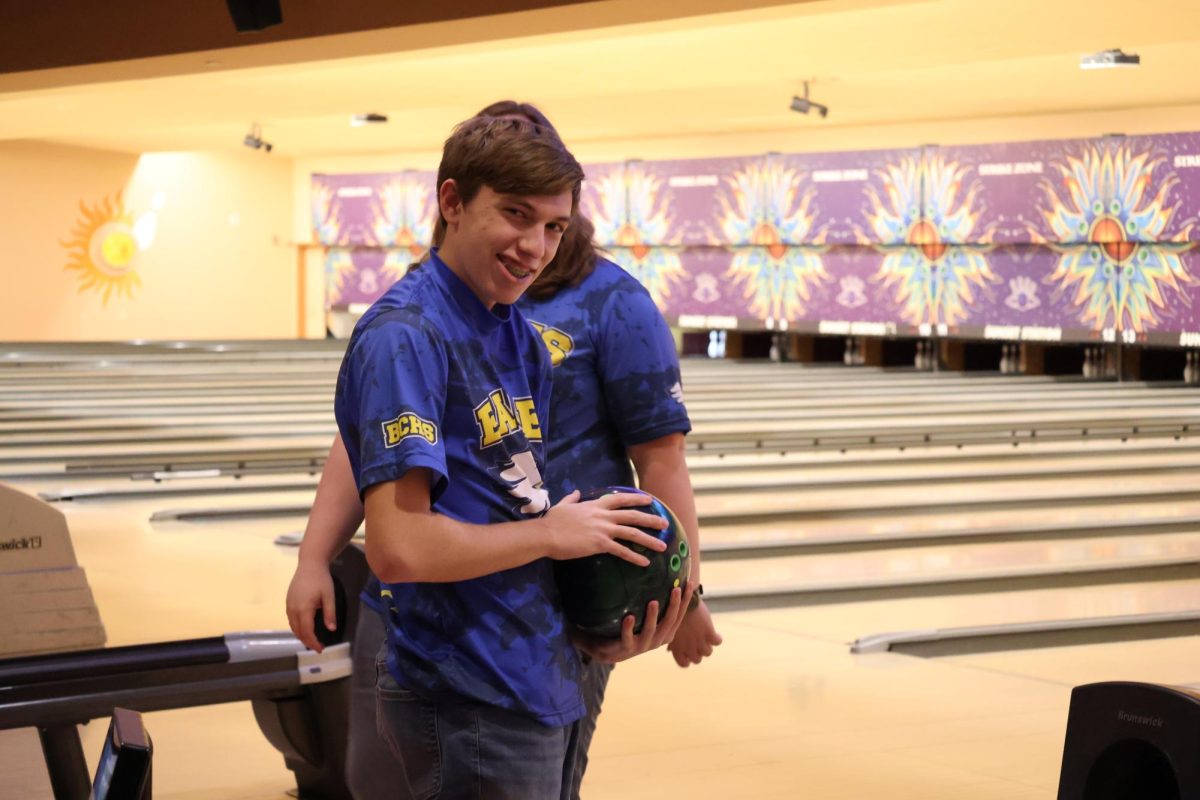 Benjamin Porter (12), about to bowl.